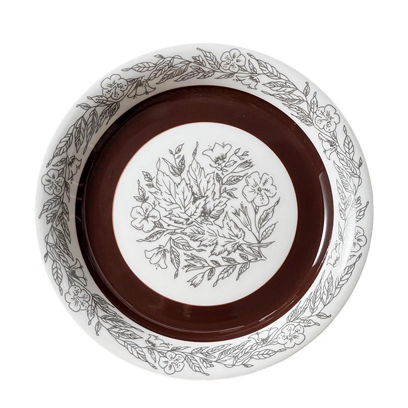 Deep porcelain plate with floral rim ornamentation and contrasting inner mirror