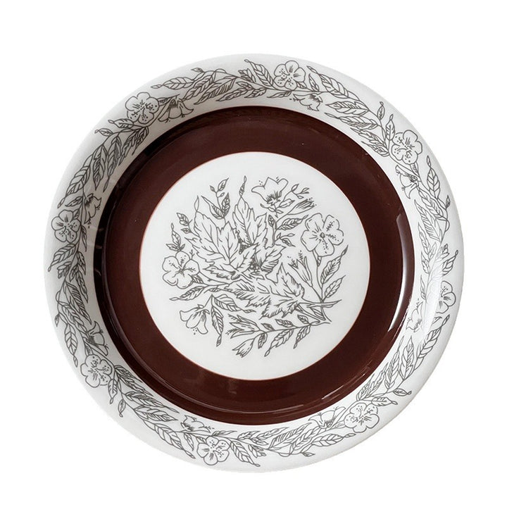 Deep porcelain plate with floral rim ornamentation and contrasting inner mirror