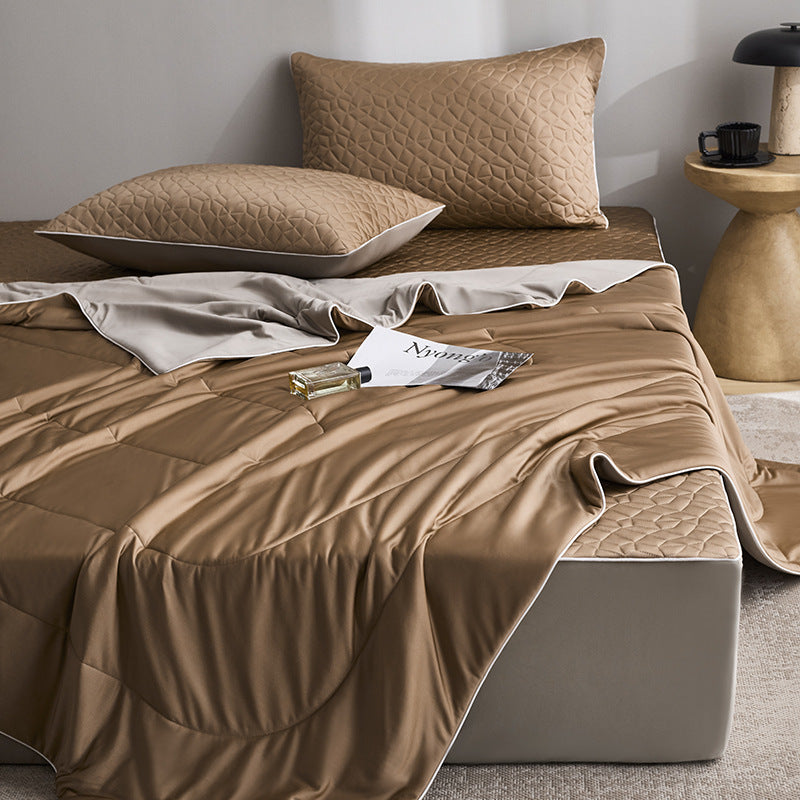 Quilted bedding set with reversible satin blanket and mattress protector