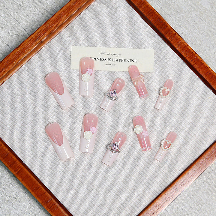 Artful nail tips with pearl and bow motifs Kalsten