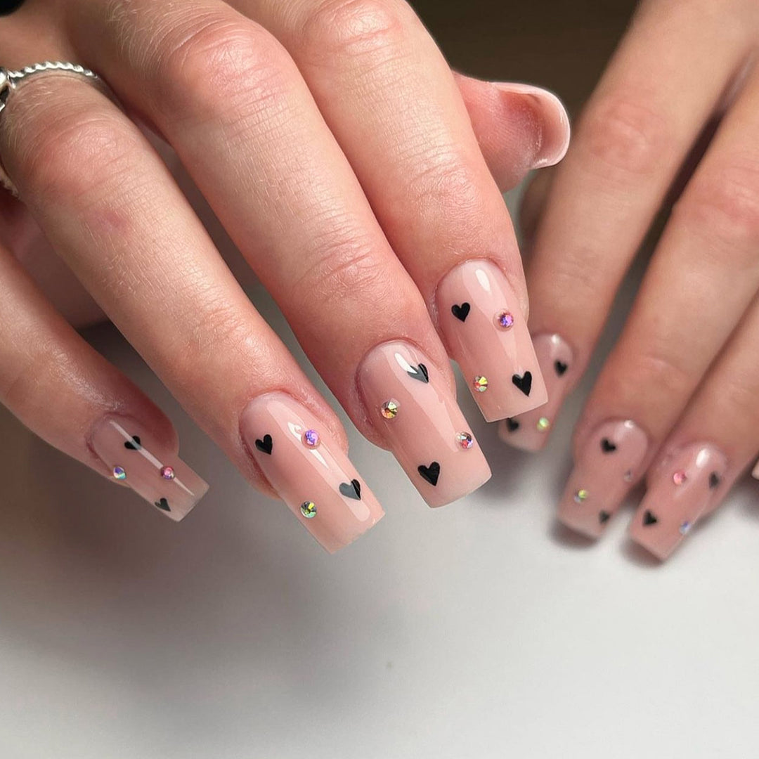 Artistic nail art with heart design and glitter accents Kalsten
