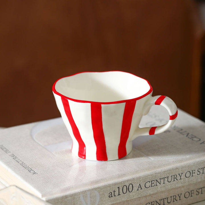 Designer stoneware coffee mug with scalloped rim and vertical brushstroke