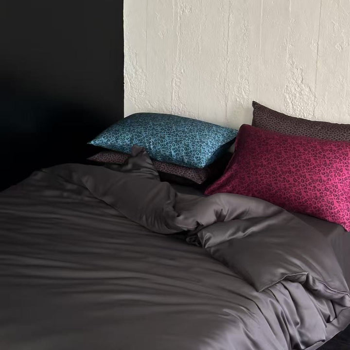 Satin bedding set with a silky sheen, smooth drape, and animal print pillows