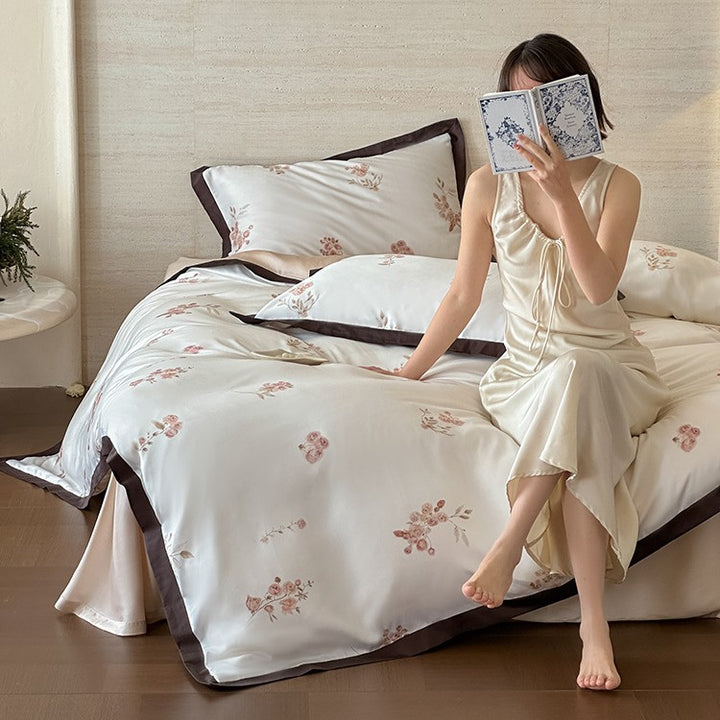 Fine satin duvet cover set with delicate floral embroidery and elegant piping