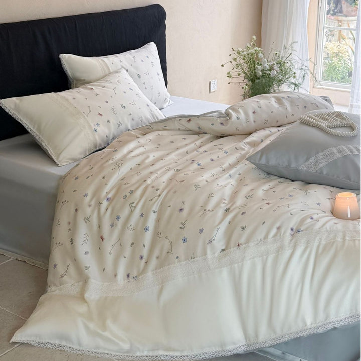 Cotton satin bedding set with delicate floral embroidery and lace trim