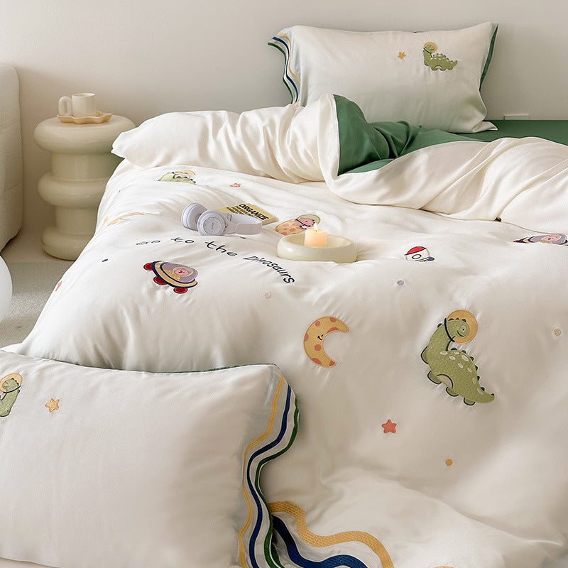 Children's bedding set with embroidered doll appliqués, ruffle and cuddle pillow