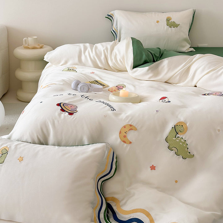 Children's bedding set with embroidered doll appliqués, ruffle and cuddle pillow