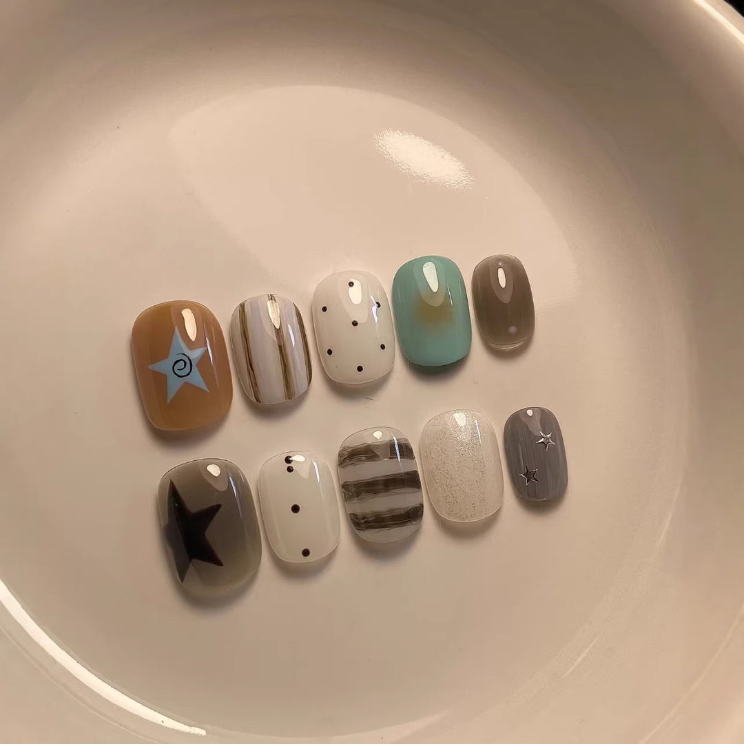 Artistic Press-On Nail Set with Abstract Patterns and Decorative Elements