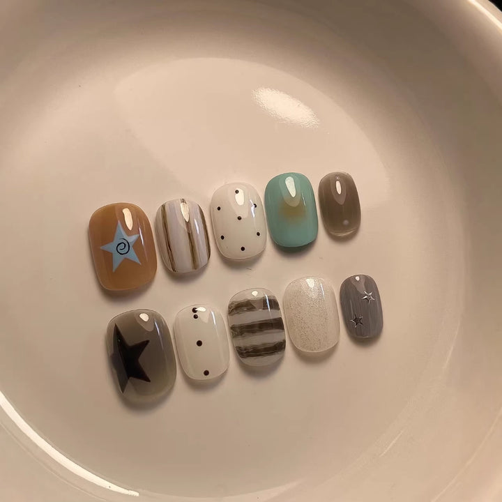 Artistic Press-On Nail Set with Abstract Patterns and Decorative Elements