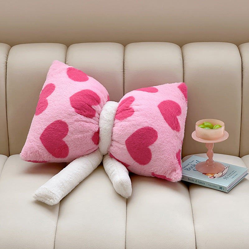 Cuddle cushion in bow shape made of plush with striped texture