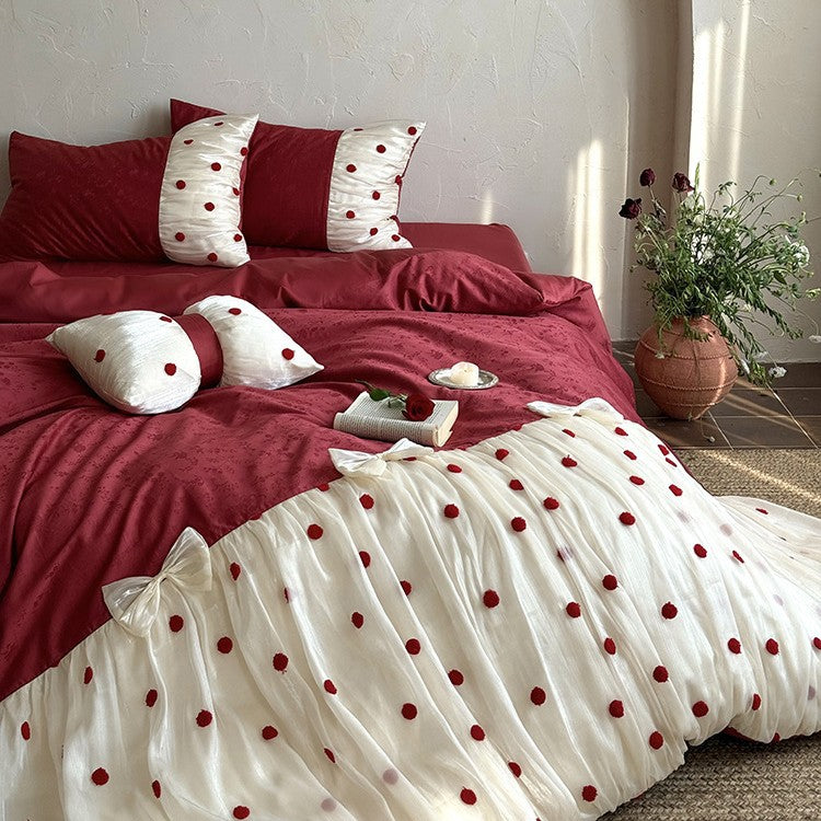 Romantic bed linen set with tulle overlay, pom pom appliqués, and decorative bows