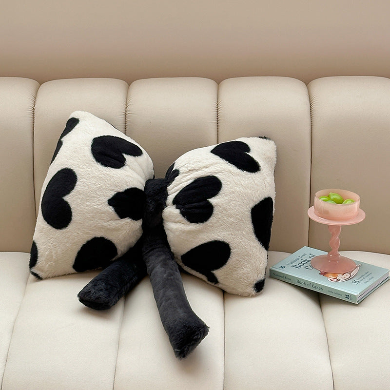 Cuddle cushion in bow shape made of plush with striped texture