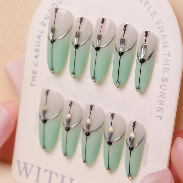 Acrylic nail set with elegant ombre effect and glamorous embellishments Kalsten