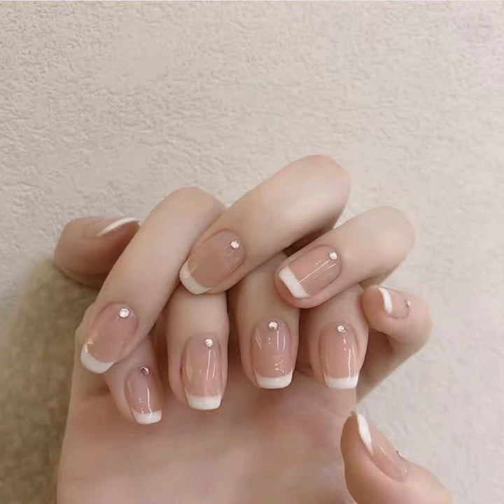 Artificial nails with elegant French tip and rhinestone accents Kalsten