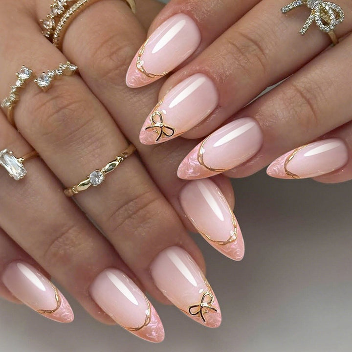 Acrylic nail set with elegant tips and gold embellishments Kalsten
