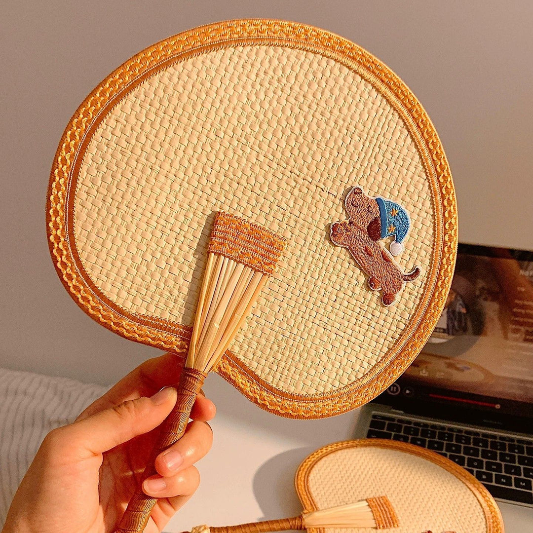 Handcrafted fan with playful dog motif Kalsten