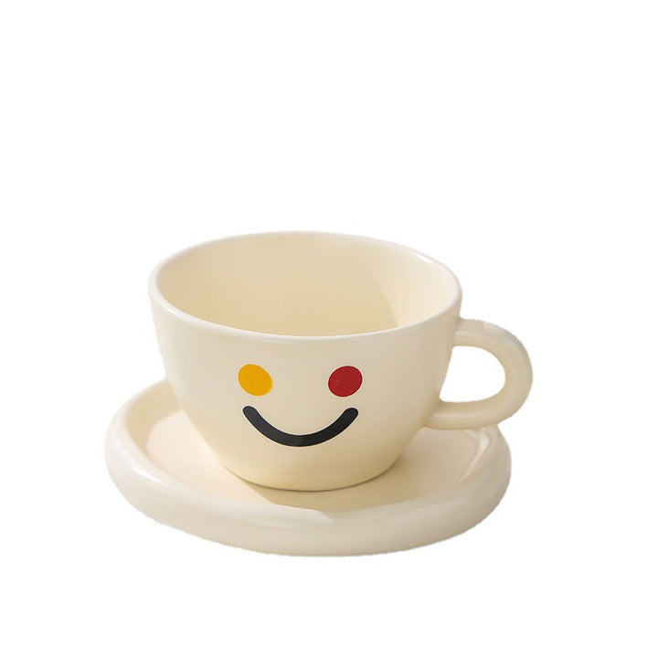 Handcrafted ceramic mug and plate set with cheerful smiley relief and organic shape