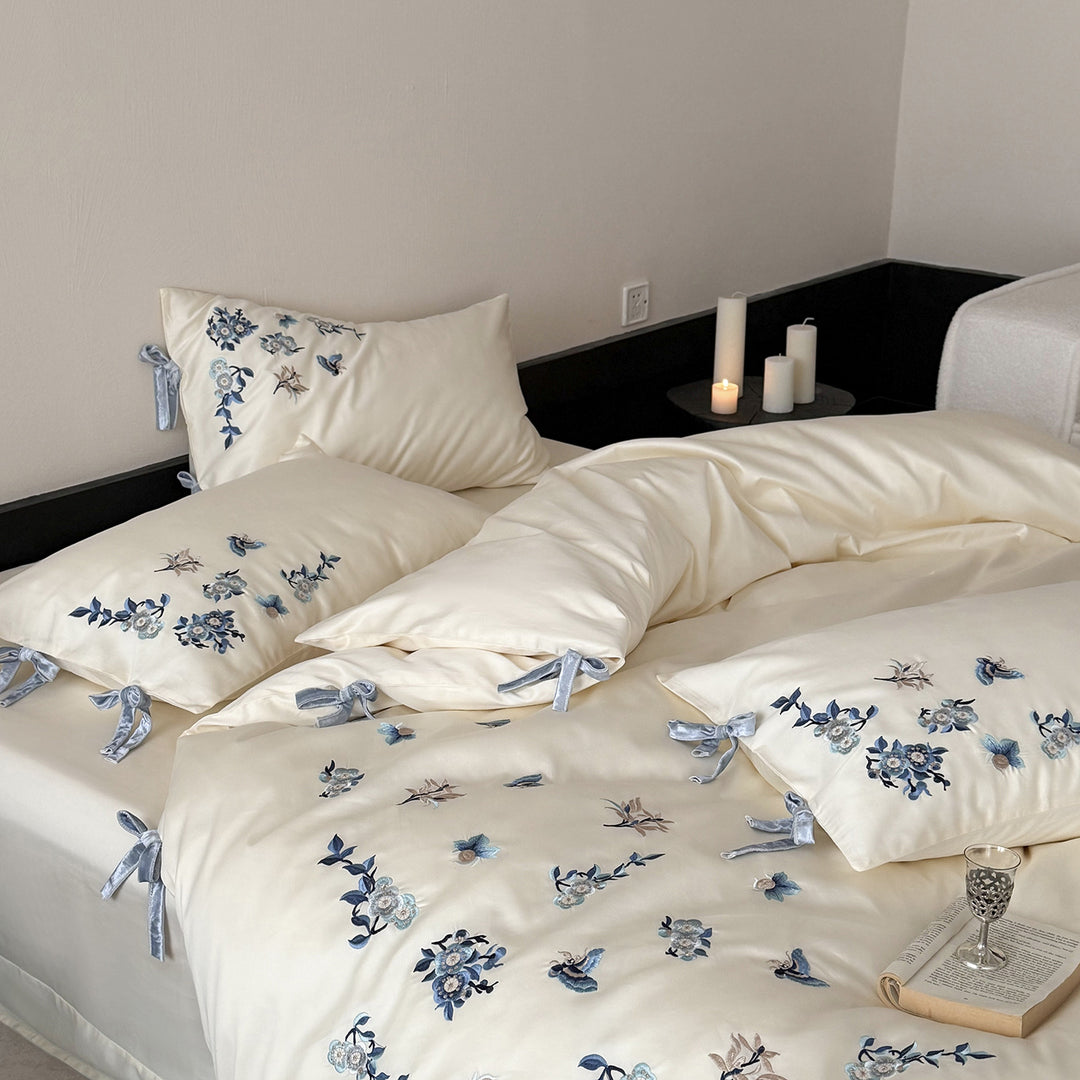 Embroidered satin bedding set with delicate floral details