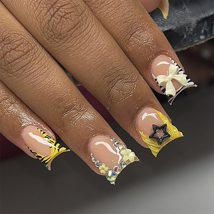 Artistic Nail Art with Glitter and Floral Accents Kalsten