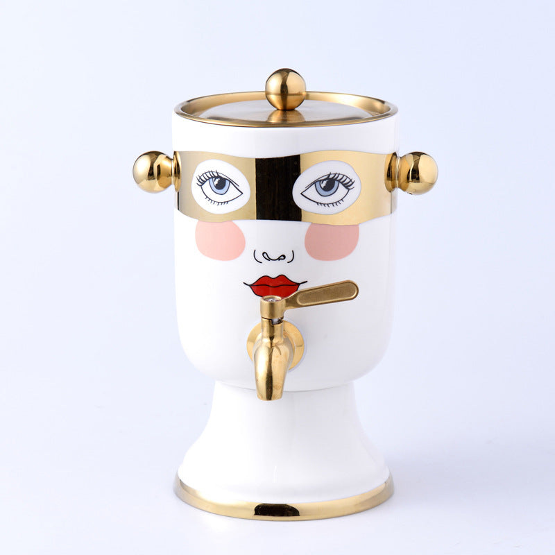 Decorative ceramic beverage dispenser with tap, hand-painted face and gold-finished lid