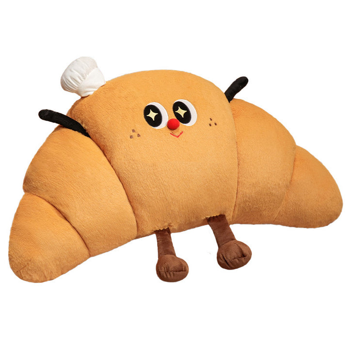 Large cuddly plush pillow in croissant shape with cute cartoon face