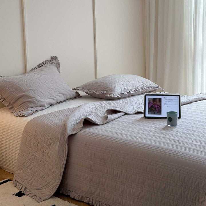 Quilted bedspread with frill and fine line quilting made of cotton blend fabric