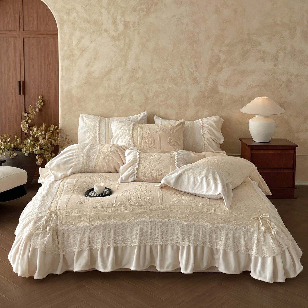 Luxury bedding set with quilted coverlet, lace ruffle, and decorative bed skirt