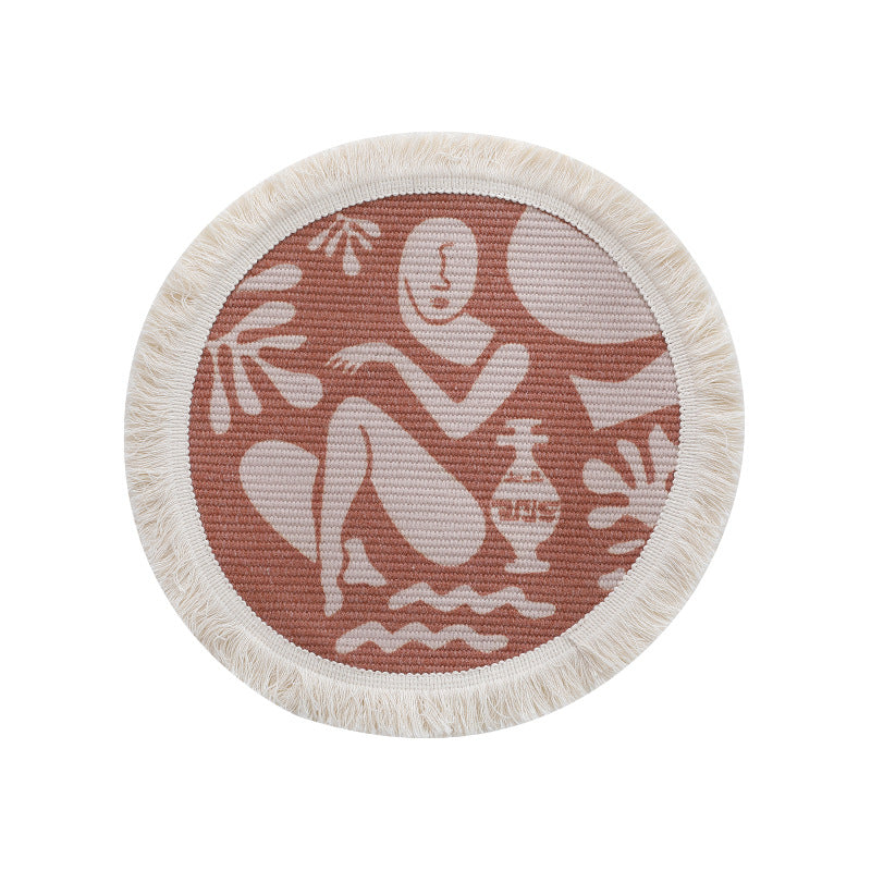 Round woven placemat with fringes and abstract figure motif Kalsten