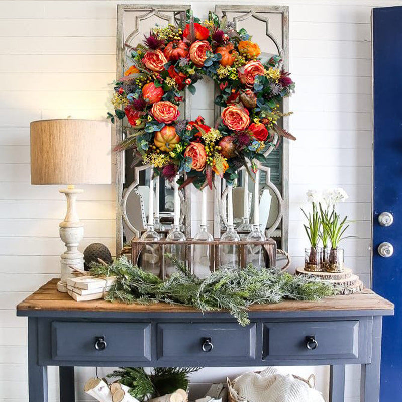 Autumn wreath with artistic roses, mini pumpkins, and eucalyptus branches