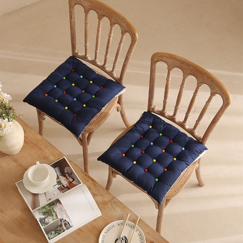 Padded quilted seat cushion with colorful button applications and non-slip underside Kalsten