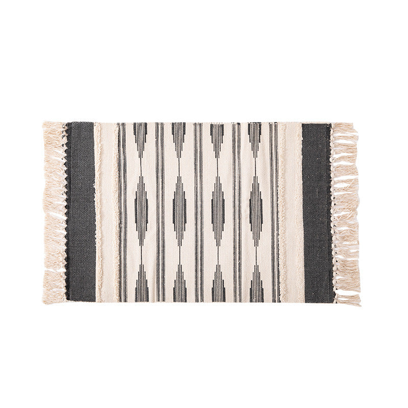 Flat Boho runner rug made of cotton blend fabric with geometric hexagon tufting and decorative fringed edge.
