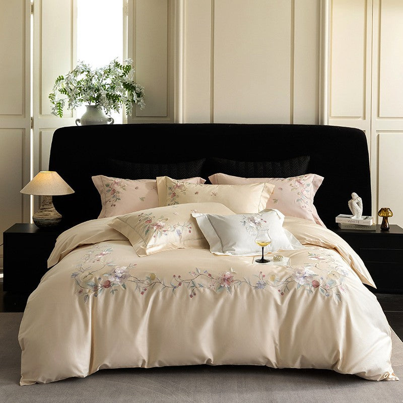 Luxurious embroidered satin bed linen set with floral corner motif and contrast piping