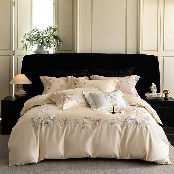 Luxurious embroidered satin bed linen set with floral corner motif and contrast piping