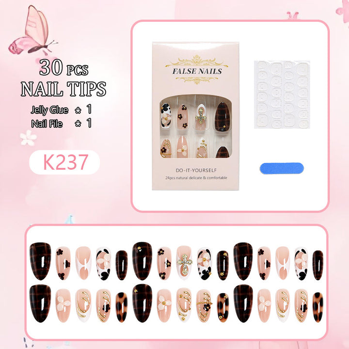 Artificial nails set with elegant gold accents and floral embellishments Kalsten