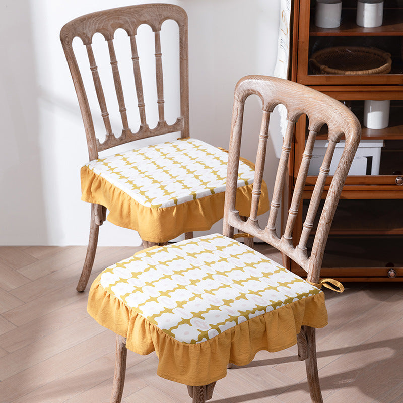 Padded chair cushion with ties, ruffled edge and embroidered hole pattern look Kalsten