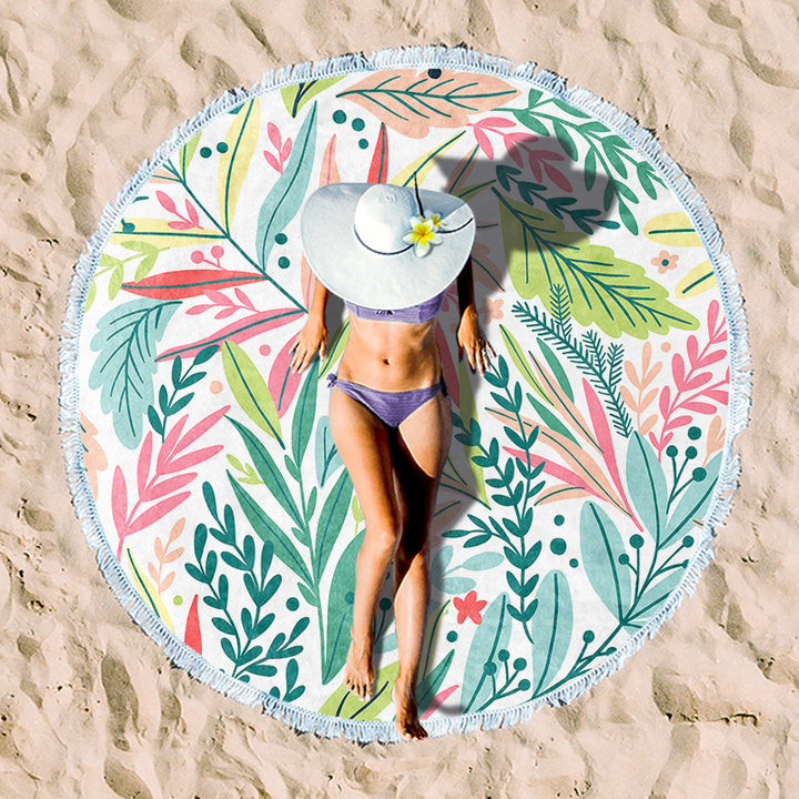 Round beach towel with colorful, tropical floral pattern and fringe decoration Kalsten