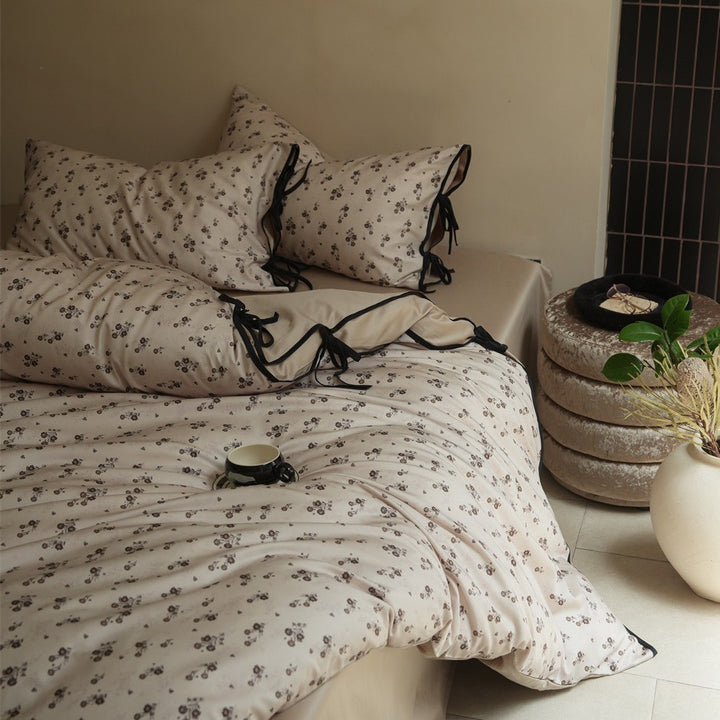 Bedding set made of cotton satin with fine floral microprint and decorative ribbons