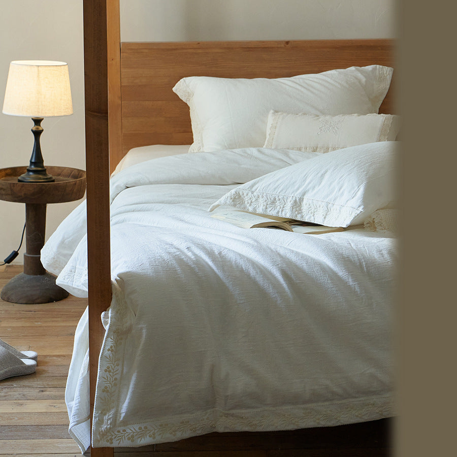 Cotton gauze bedding set with fine tone-on-tone floral embroidery and ruffle