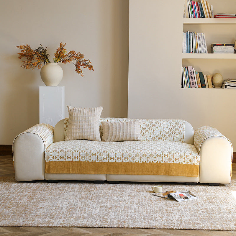 Knitted sofa cover with jacquard pattern and reinforced hem border Kalsten