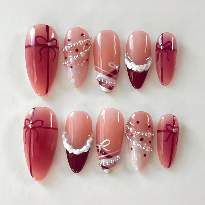 Nail set with glamorous bows and elegant pearl embellishments Kalsten