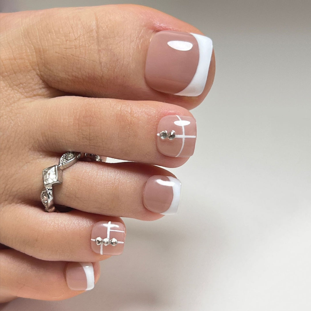 Artful toenail design with elegant style and rhinestone embellishments Kalsten