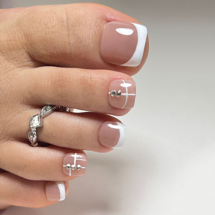 Artful toenail design with elegant style and rhinestone embellishments Kalsten