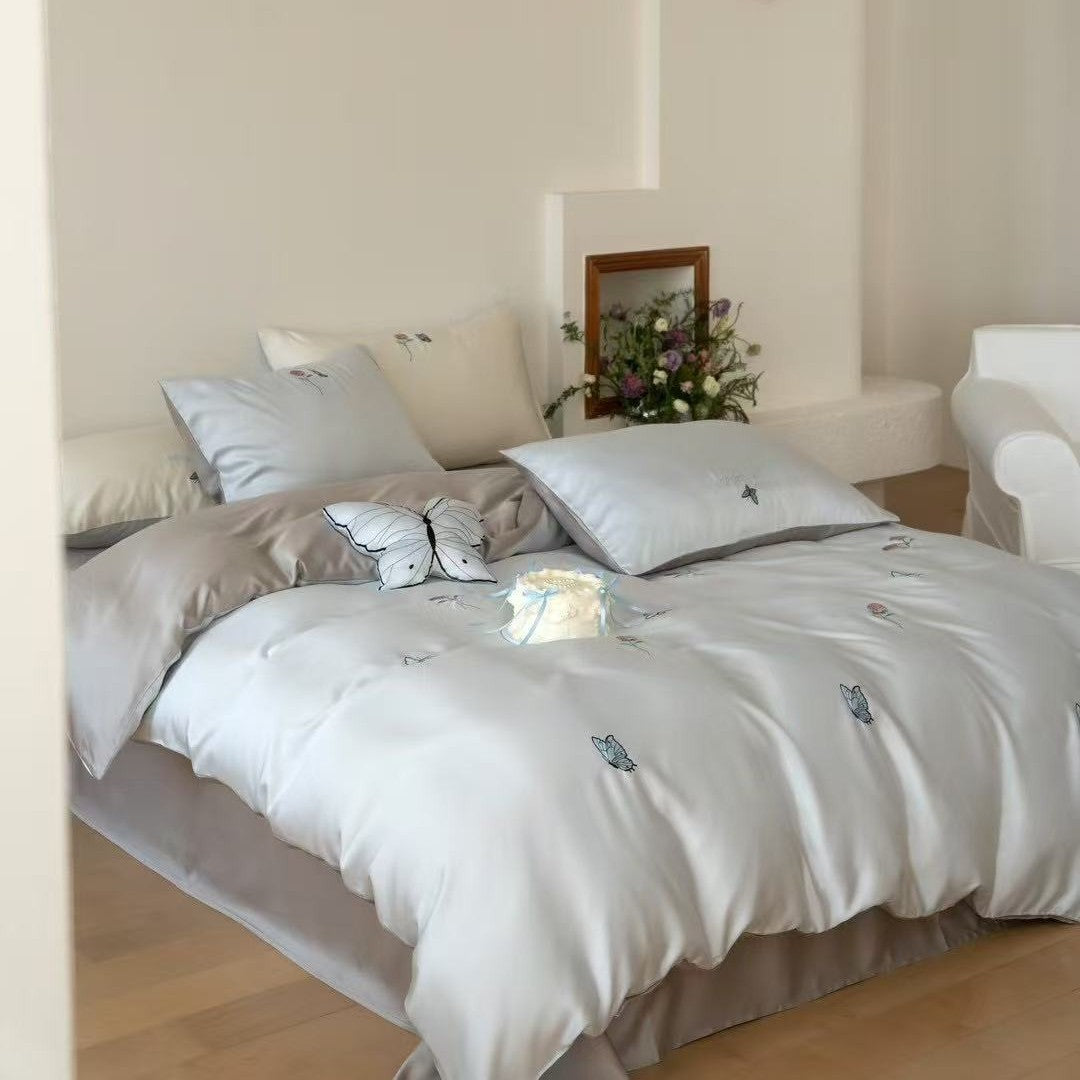 Luxurious satin bedding set with embroidered cherry motifs, reversible function and plush bunny pillow