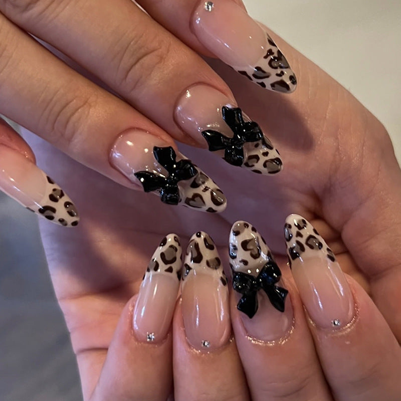 Creative artificial nails with stylish leopard pattern and bow accents Kalsten