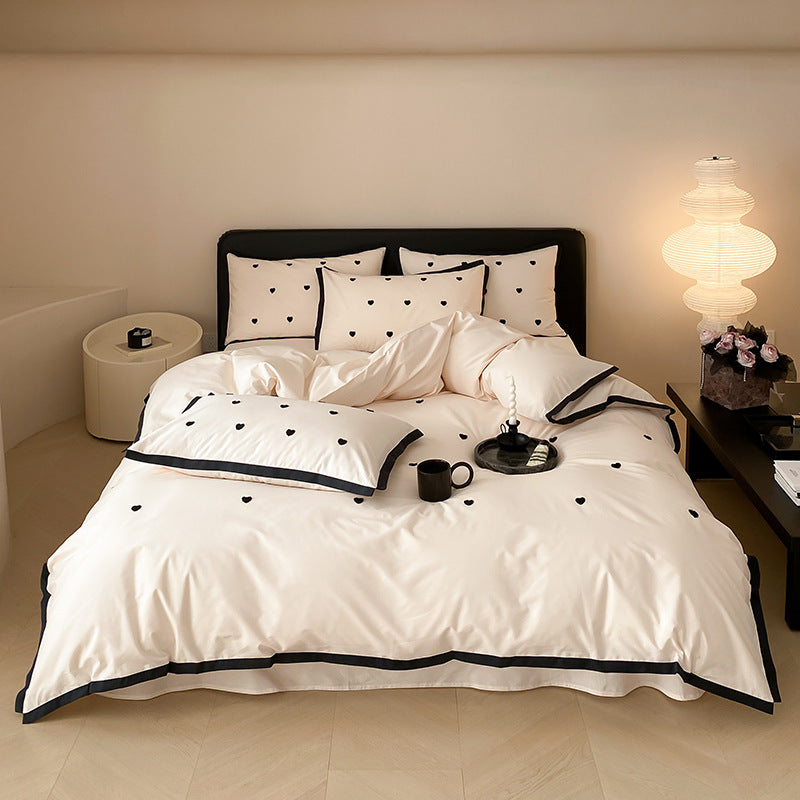 High-quality cotton satin bedding set with delicate embroidery, reversible feature & piping edge