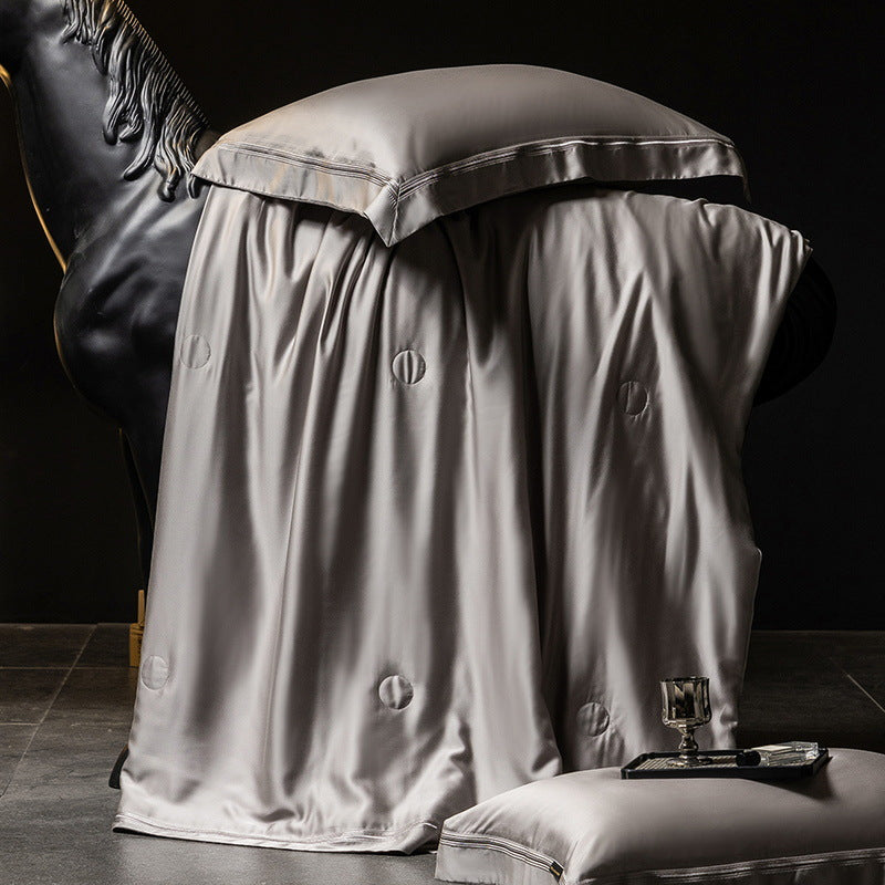 Luxurious satin bed set with silk-like surface and fine decorative stitching