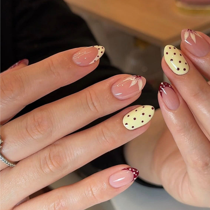 Artistic nail design with unique dots and floral embellishments Kalsten