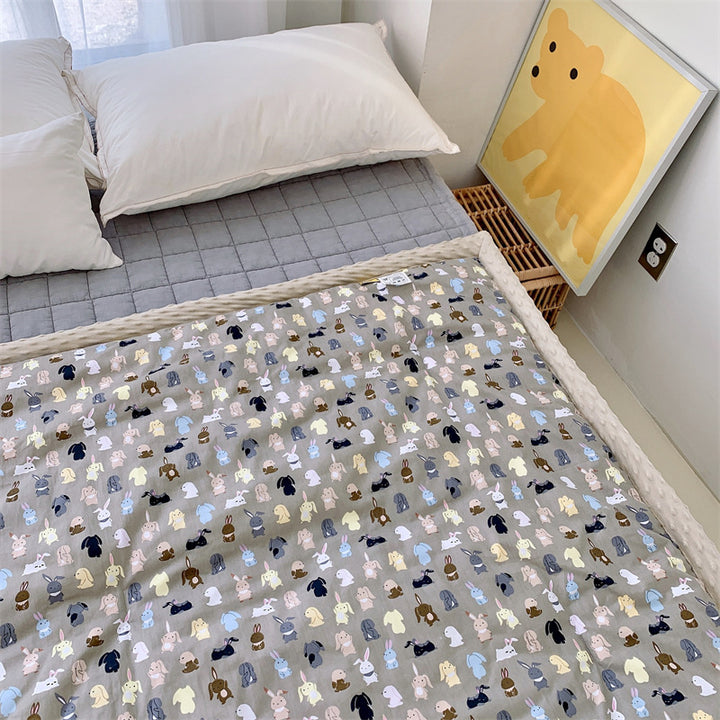 Children's quilt with colorful dinosaur print and soft minky border