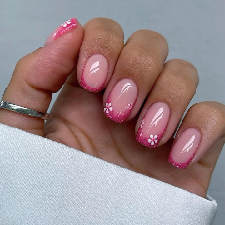 Artistic nail art with floral accent and glitter Kalsten