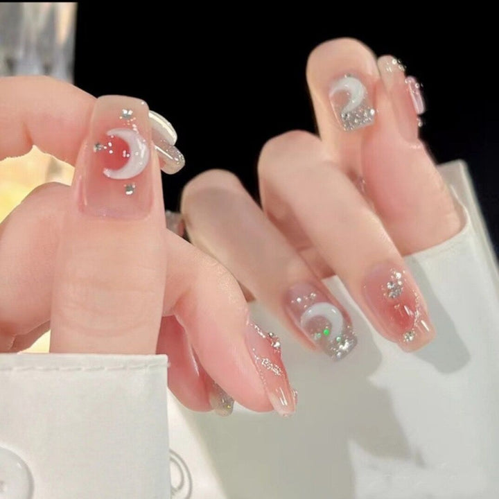 Glamorous artificial fingernails with glitter and moon designs Kalsten